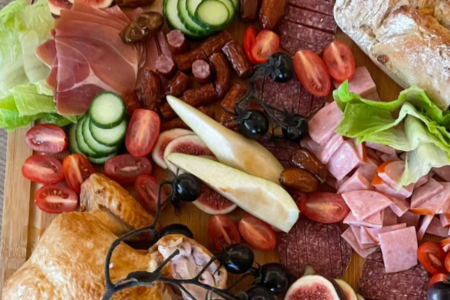 charcuterie board full of food for hosting